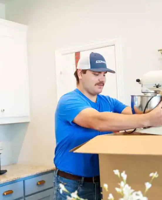 A1A mover packing kitchen items into a box