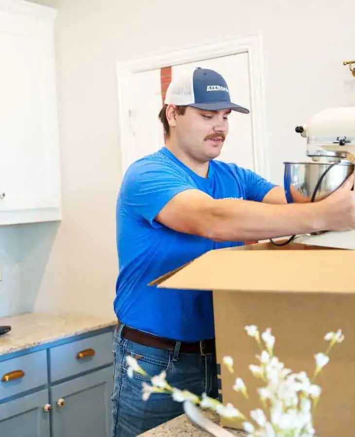A1A mover packing kitchen items into a box