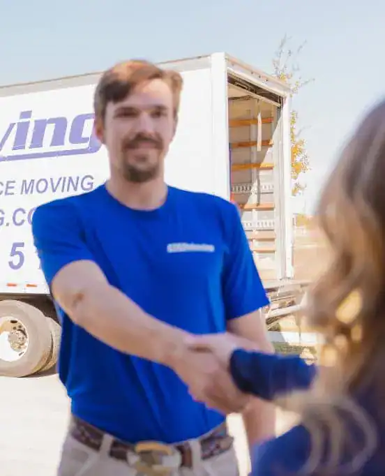 A1A mover shaking hands with a customer next to the truck