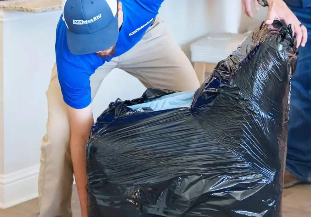 A1A mover shrink-wrapping a chair in plastic
