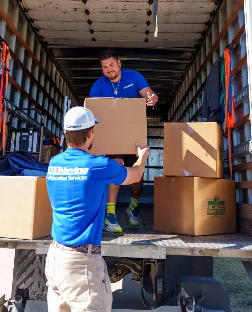 A1A movers handing boxes down from the moving truck