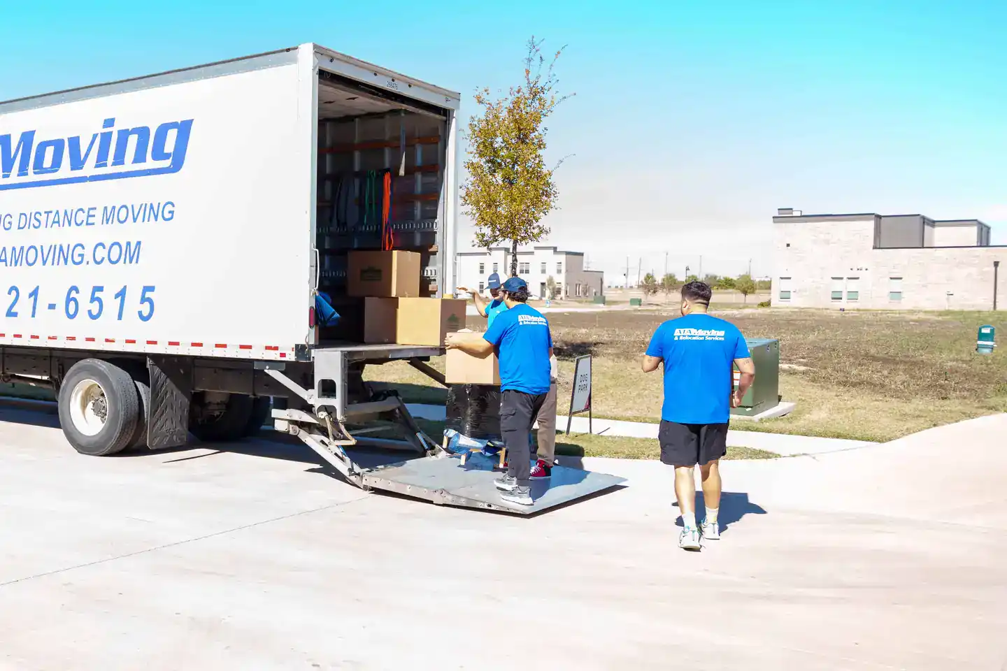 A1A movers unloading boxes from the moving truck lift gate