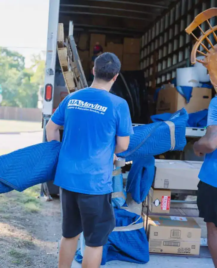 A1A movers unloading padded furniture from the truck