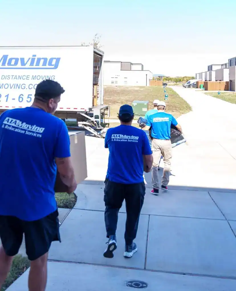 A1A movers walking up to a home from the moving truck