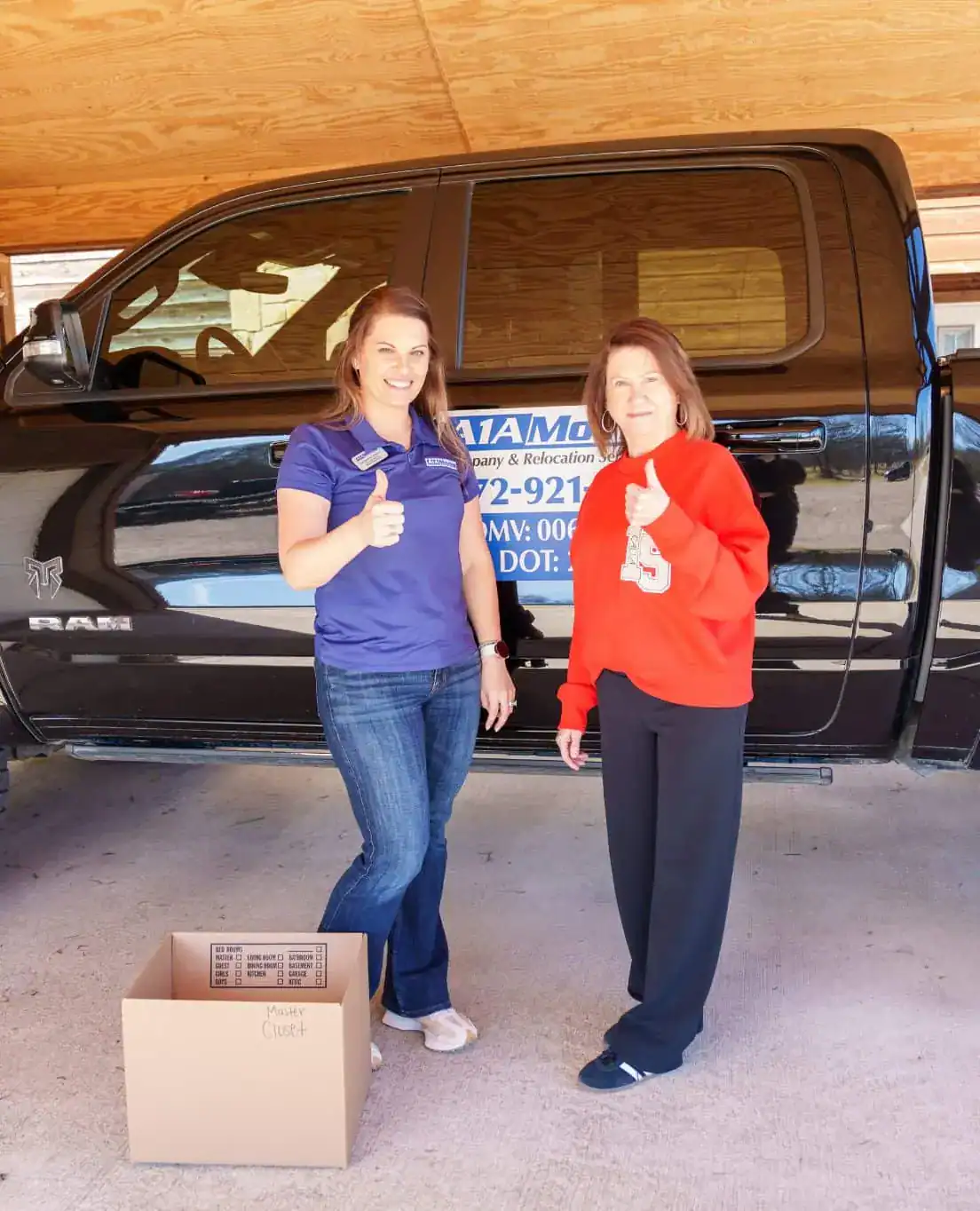 A1A team member and a happy customer in a garage after a move
