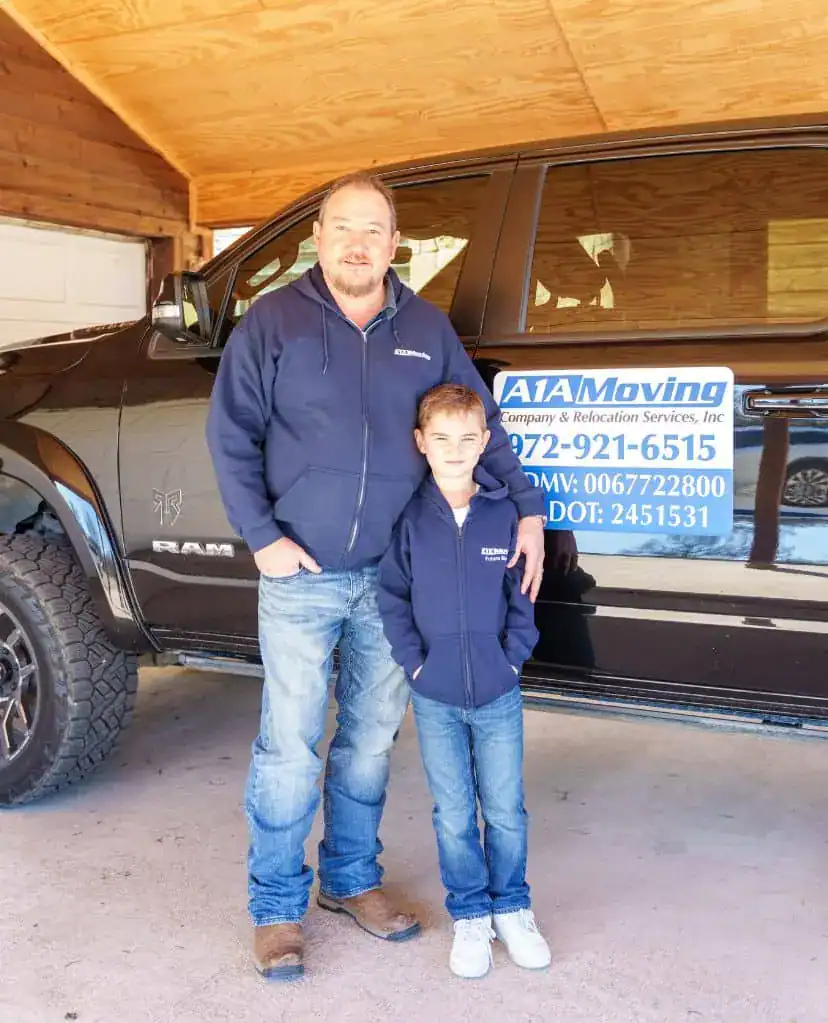 A1A team member and a young boy in front of an A1A pickup truck