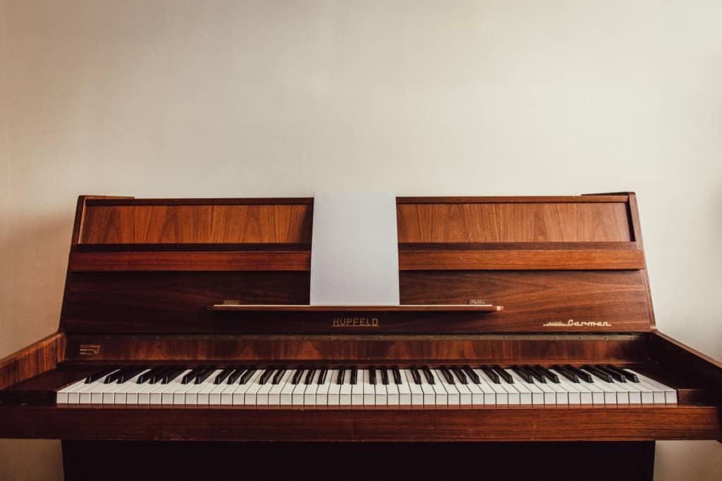 Wooden upright piano in a home before a piano move