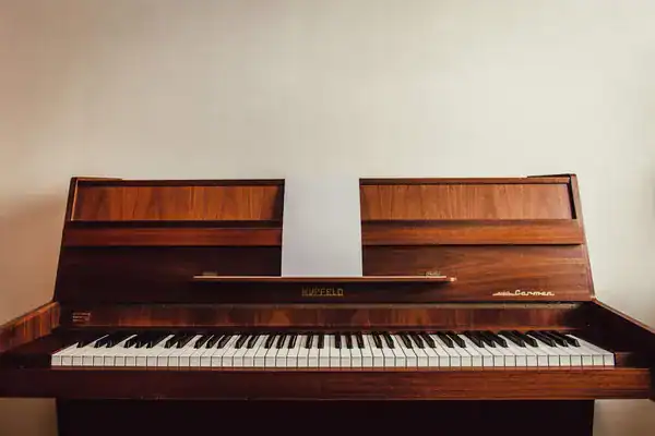 Wooden upright piano in a home before a piano move