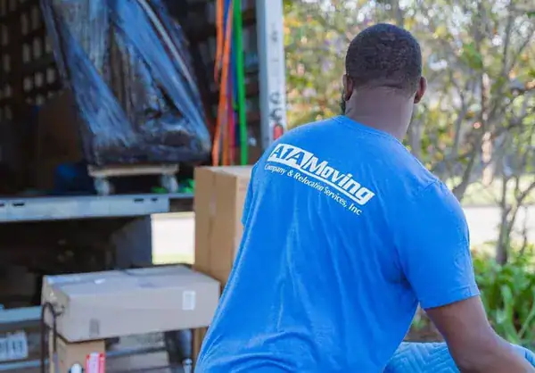 A1A mover wheeling padded furniture to the moving truck
